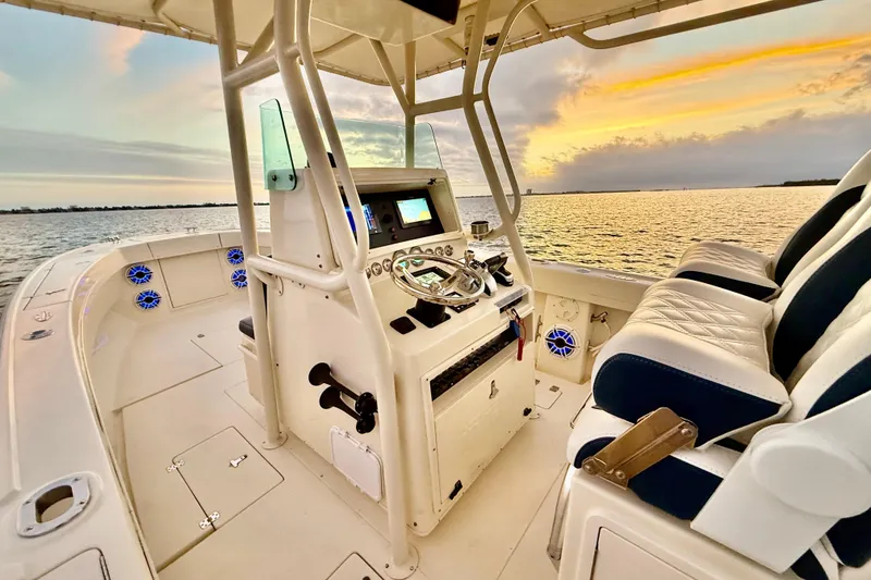 Slide: The Image of 2003 Intrepid 289 Center Console boat interior at sunset on the water. - 49