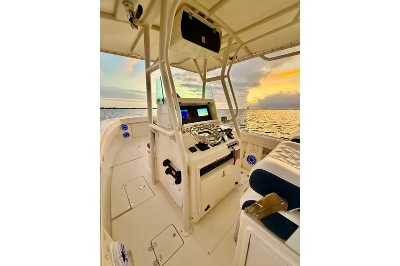 Slide: The Image of 2003 Intrepid 289 Center Console boat interior at sunset on the water. - 50