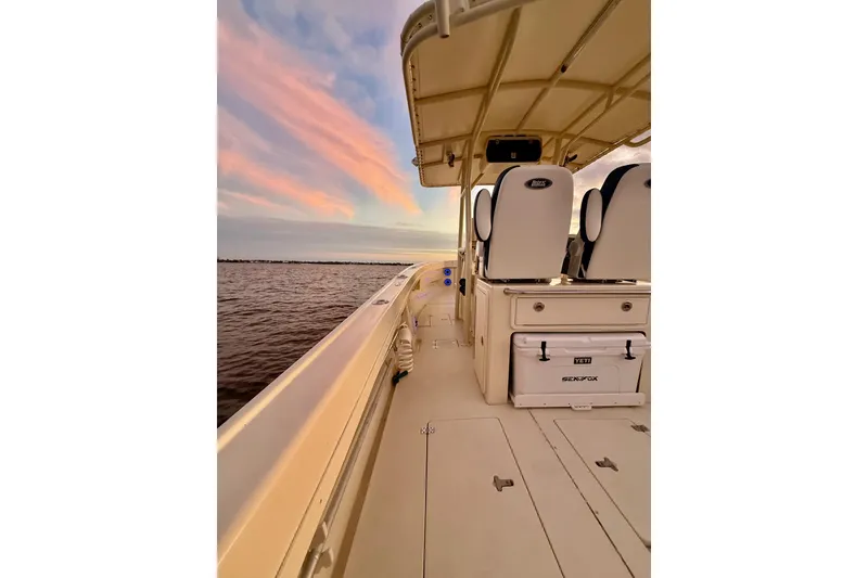 Slide: The Image of 2003 Intrepid 289 Center Console boat at sunset on calm waters. - 53