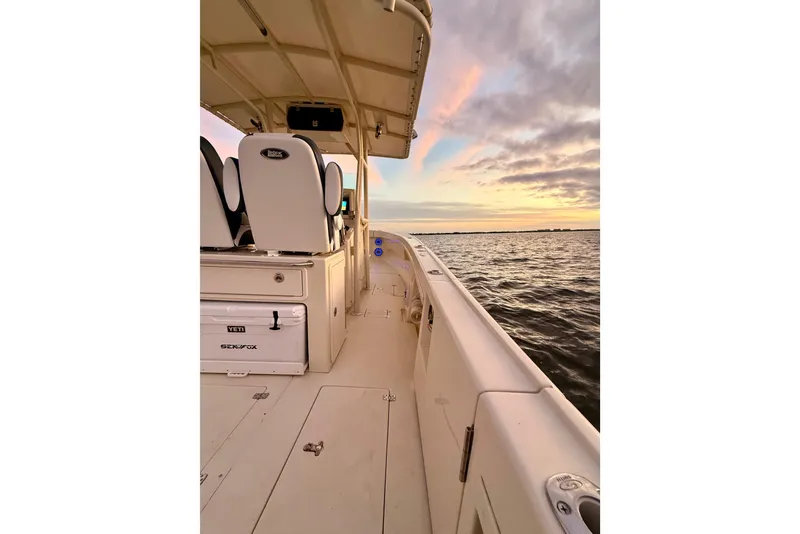Slide: The Image of 2003 Intrepid 289 Center Console boat on water at sunset. - 54