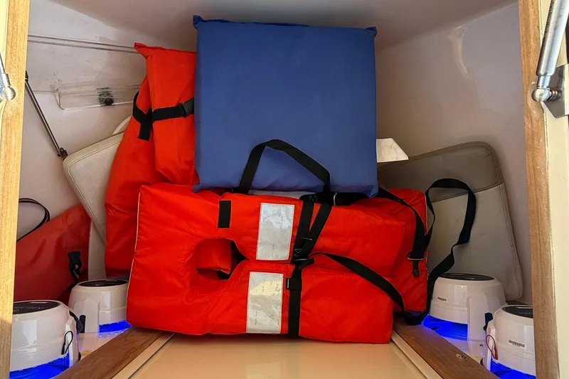 Slide: The Image of Storage compartment with life jackets and cushions on a 2003 Intrepid 289 Center Console boat. - 57