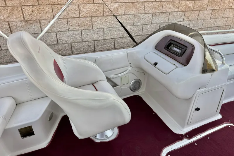 Slide: The Image of 2000 Godfrey Hurricane 2100 Sundeck boat interior with white seating and maroon carpet. - 16