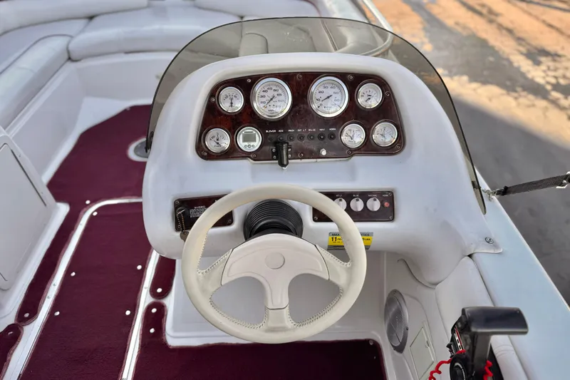 Slide: The Image of Steering console of a 2000 Godfrey Hurricane 2100 Sundeck boat with gauges and controls. - 19
