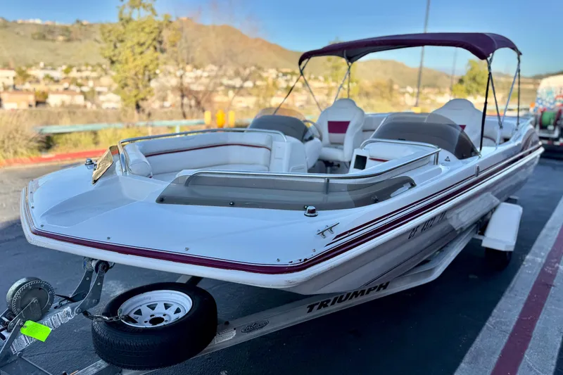 Slide: The Image of 2000 Godfrey Hurricane 2100 Sundeck boat on trailer, parked outdoors. - 3