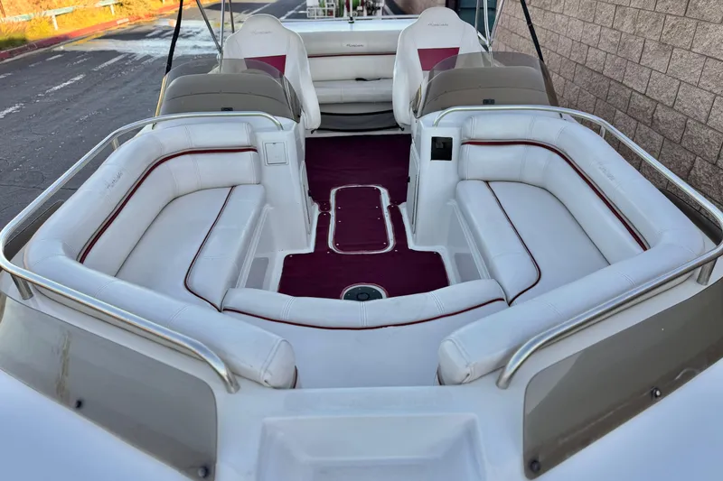 Slide: The Image of 2000 Godfrey Hurricane 2100 Sundeck boat with white seating and red accents. - 7