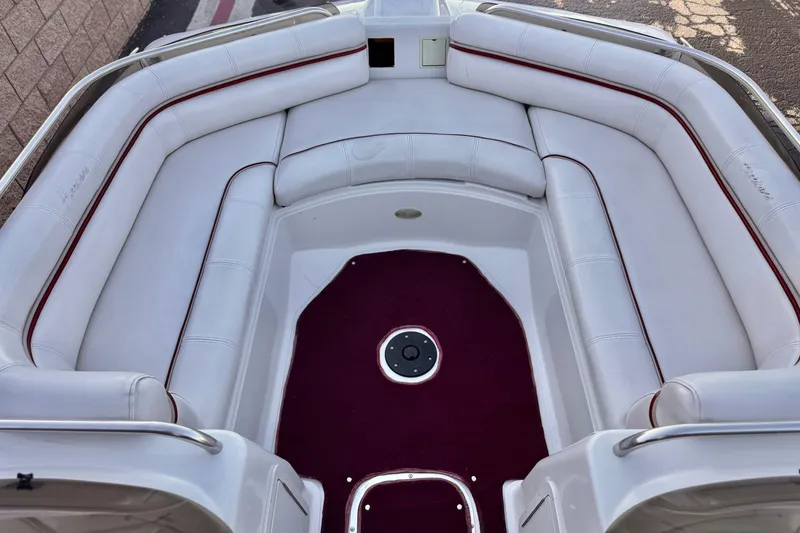 Slide: The Image of 2000 Godfrey Hurricane 2100 Sundeck boat interior with white seating and red accents. - 8