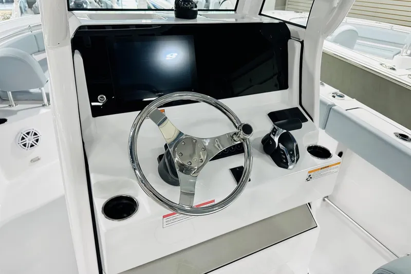 Slide: The Image of 2026 Sportsman Open 232 Center Console dashboard with steering wheel and controls. - 3