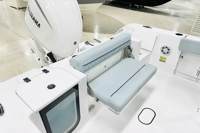 Slide: The Image of 2026 Sportsman Open 232 Center Console boat interior with Yamaha engine and cushioned seating. - 14