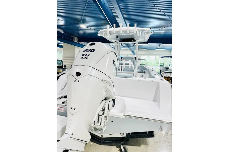 Slide: The Image of 2026 Sportsman Open 232 Center Console boat with powerful 300 V6 engine in showroom. - 16