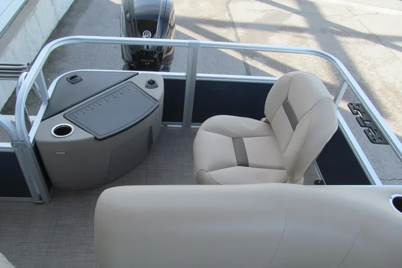 Slide: The Image of 2024 Sun Tracker Bass Buggy 18 DLX interior with beige seating and fishing station. - 12