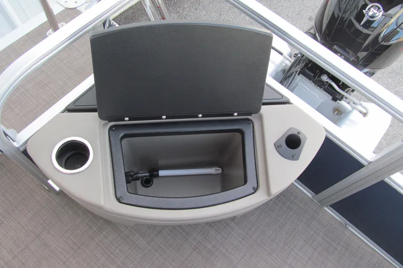 Slide: The Image of 2024 Sun Tracker Bass Buggy 18 DLX storage compartment with cup holder and rod holder. - 13