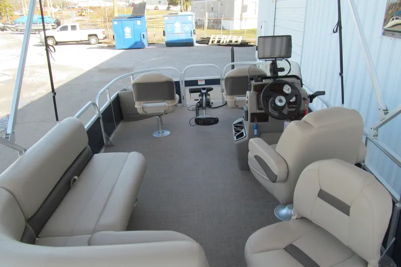Slide: The Image of 2024 Sun Tracker Bass Buggy 18 DLX pontoon boat interior with seating and steering console. - 4