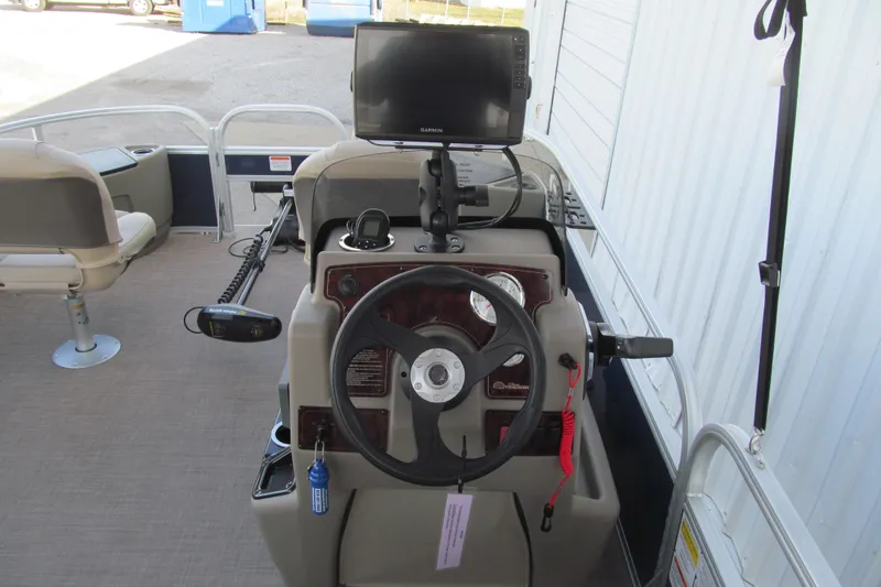Slide: The Image of 2024 Sun Tracker Bass Buggy 18 DLX helm with steering wheel and navigation system. - 5