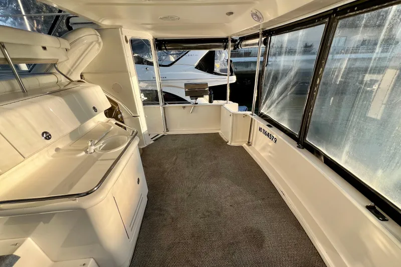 Slide: The Image of 1997 Sea Ray 370 Aft Cabin interior with sink and large windows. - 11