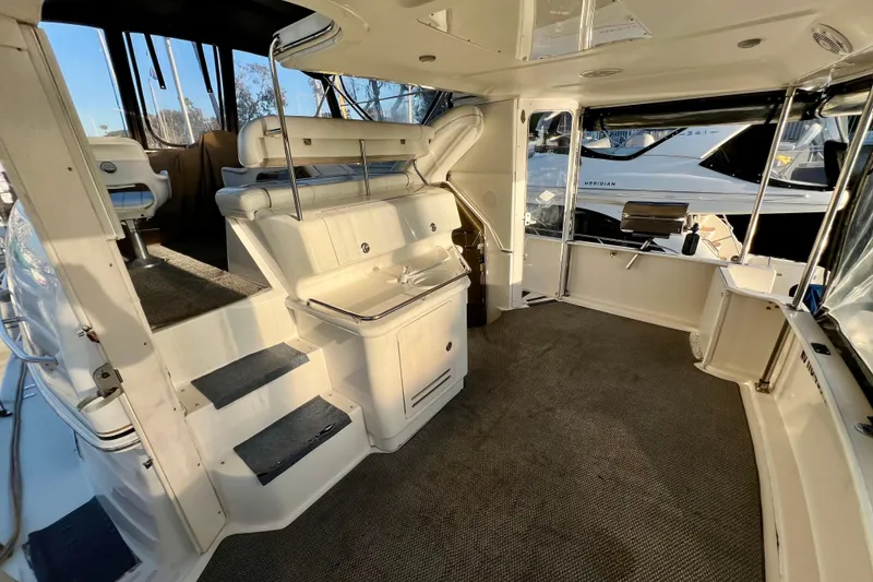 Slide: The Image of 1997 Sea Ray 370 Aft Cabin interior with seating and steps, featuring modern design. - 12