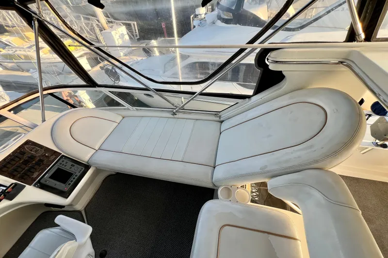 Slide: The Image of 1997 Sea Ray 370 Aft Cabin interior with white seating and control panel. - 23