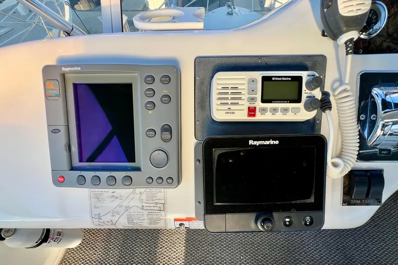 Slide: The Image of 1997 Sea Ray 370 Aft Cabin helm with Raymarine navigation and communication equipment. - 27