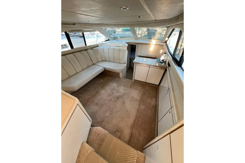 Slide: The Image of Interior of 1997 Sea Ray 370 Aft Cabin with beige seating and carpet. - 28