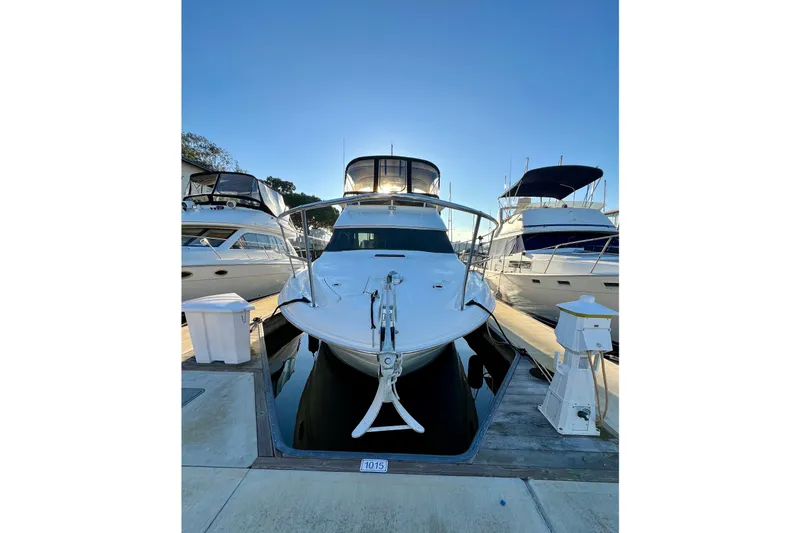 Slide: The Image of 1997 Sea Ray 370 Aft Cabin yacht docked at marina under clear blue sky. - 3