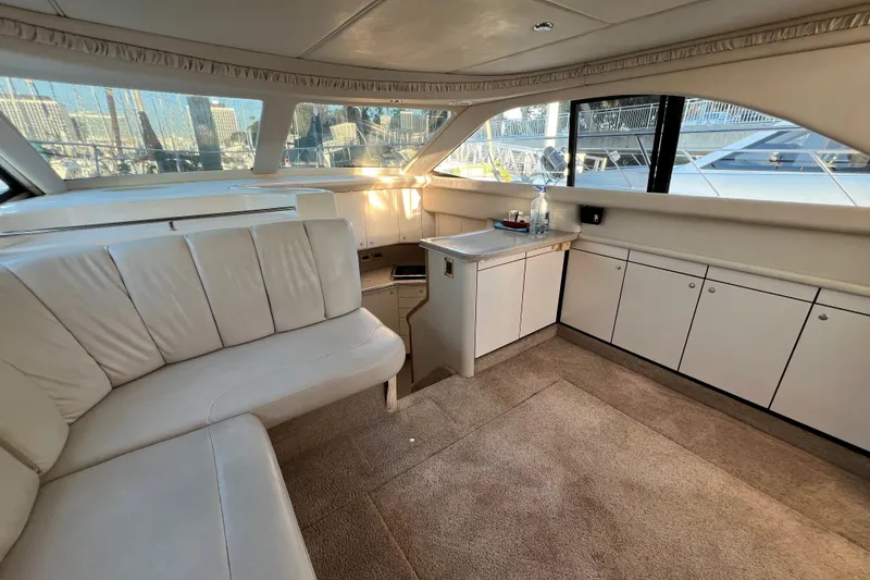 Slide: The Image of Interior of 1997 Sea Ray 370 Aft Cabin yacht with white seating and cabinetry. - 30