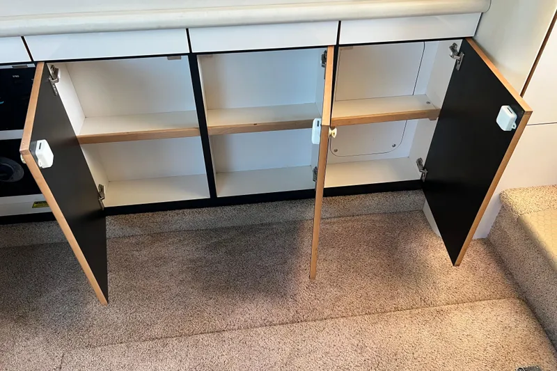 Slide: The Image of Open cabinet doors in 1997 Sea Ray 370 Aft Cabin interior, revealing storage space. - 32