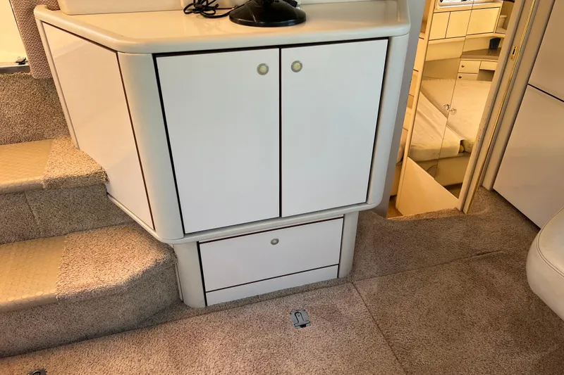 Slide: The Image of 1997 Sea Ray 370 Aft Cabin interior with carpeted stairs and storage cabinets. - 34