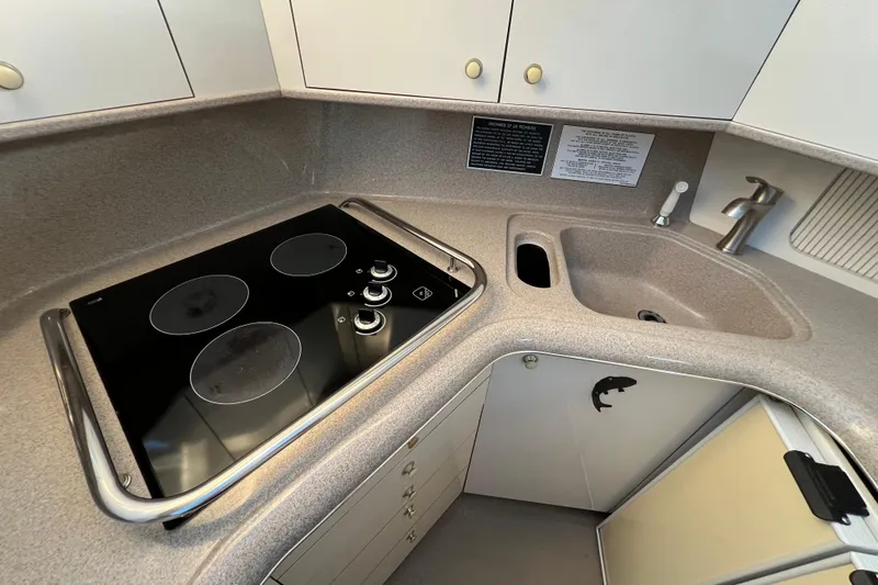 Slide: The Image of 1997 Sea Ray 370 Aft Cabin kitchen with stovetop and sink. - 40