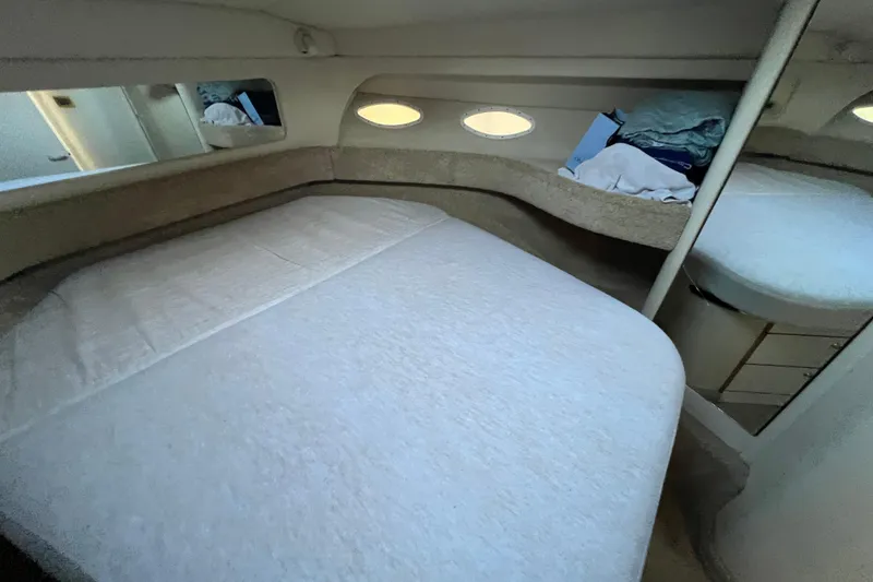 Slide: The Image of 1997 Sea Ray 370 Aft Cabin interior with cozy bed and storage space. - 51