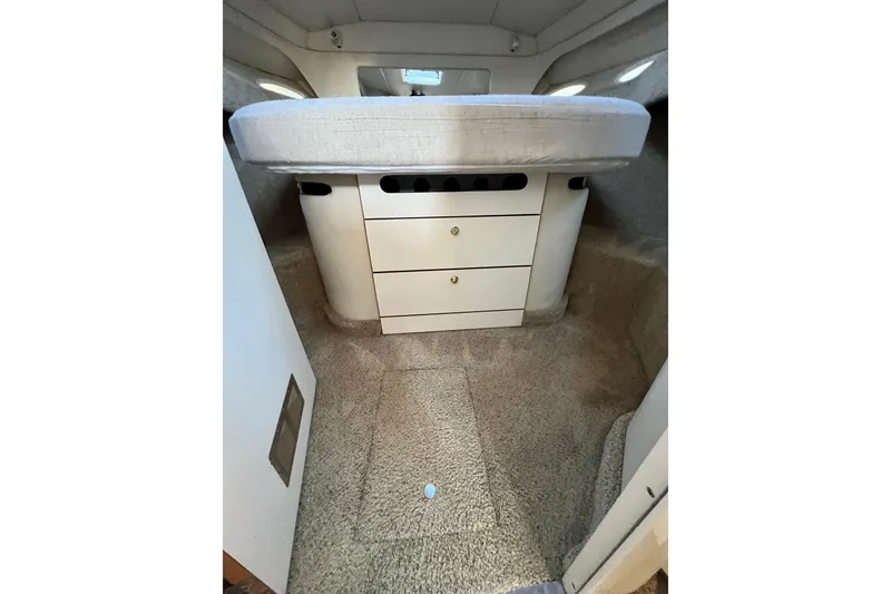 Slide: The Image of 1997 Sea Ray 370 Aft Cabin interior with bed and storage drawers. - 52
