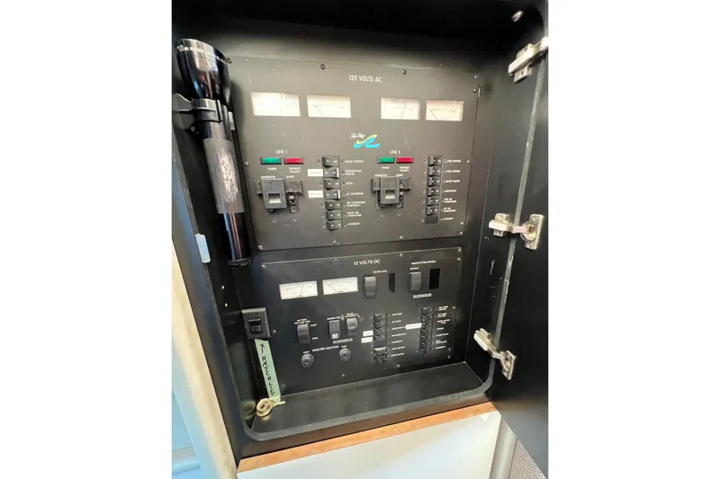 Slide: The Image of Electrical panel of a 1997 Sea Ray 370 Aft Cabin boat with switches and gauges. - 62