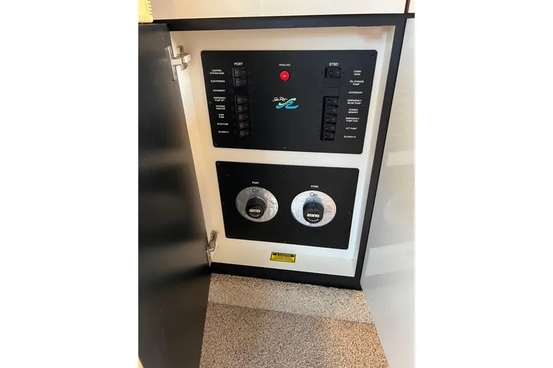 Slide: The Image of Electrical panel of 1997 Sea Ray 370 Aft Cabin boat, showing switches and controls. - 64