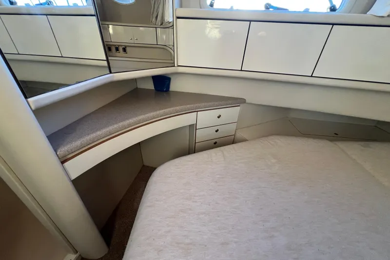 Slide: The Image of 1997 Sea Ray 370 Aft Cabin interior with bed, cabinets, and window. - 68