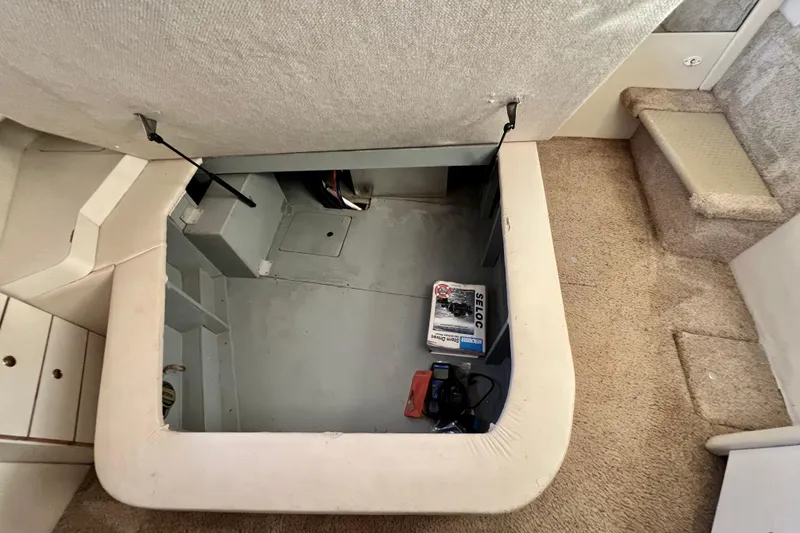 Slide: The Image of 1997 Sea Ray 370 Aft Cabin storage compartment with manual and equipment. - 70