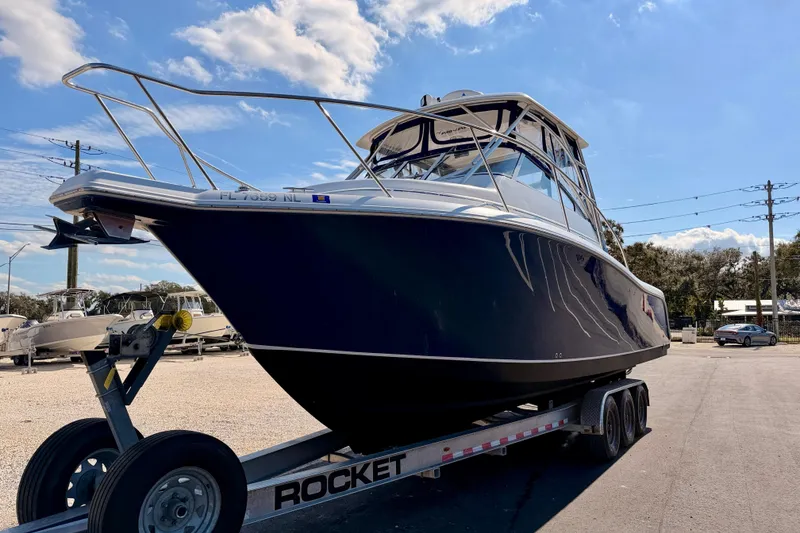 Slide: The Image of 2007 Pro-Line 32 Express boat on trailer under clear blue sky. - 1