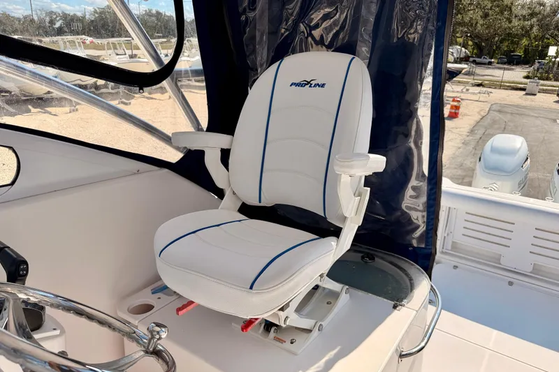 Slide: The Image of Captain's chair on 2007 Pro-Line 32 Express boat, featuring white upholstery and blue accents. - 10