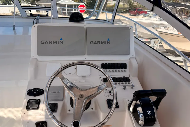 Slide: The Image of 2007 Pro-Line 32 Express boat helm with Garmin navigation system and controls. - 11