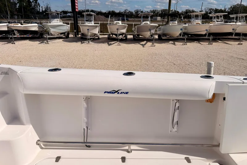 Slide: The Image of 2007 Pro-Line 32 Express boat interior with rod holders, docked with other boats. - 24