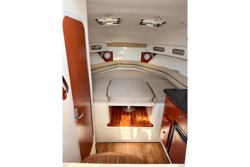 Slide: The Image of 2007 Pro-Line 32 Express cabin interior with cozy seating and wooden accents. - 25