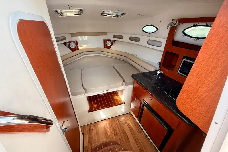 Slide: The Image of 2007 Pro-Line 32 Express cabin interior with kitchenette and seating area. - 26