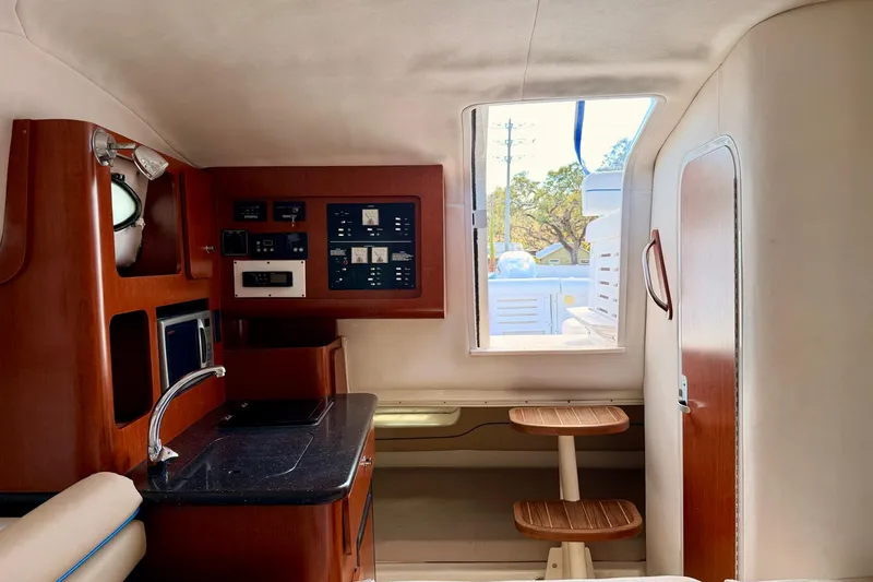 Slide: The Image of 2007 Pro-Line 32 Express cabin interior with kitchenette and control panel. - 28