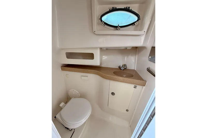 Slide: The Image of 2007 Pro-Line 32 Express boat bathroom with sink, toilet, and porthole window. - 32