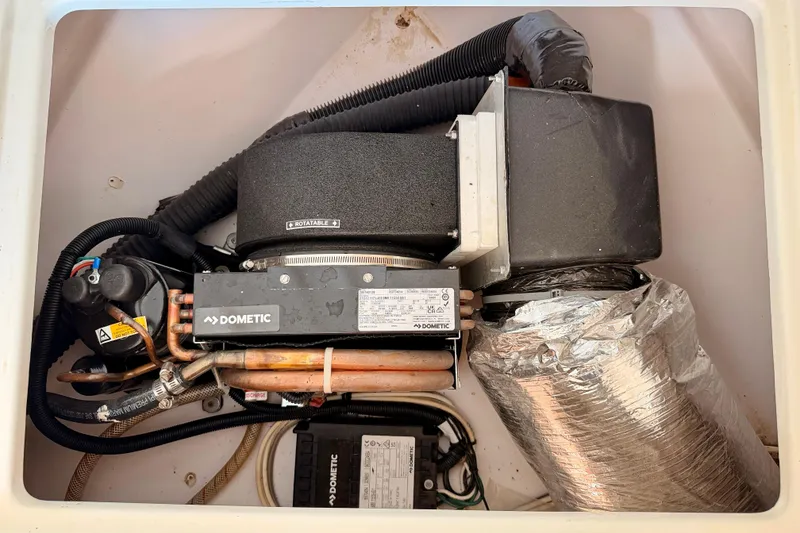 Slide: The Image of 2007 Pro-Line 32 Express boat air conditioning unit by Dometic, featuring rotatable components. - 37