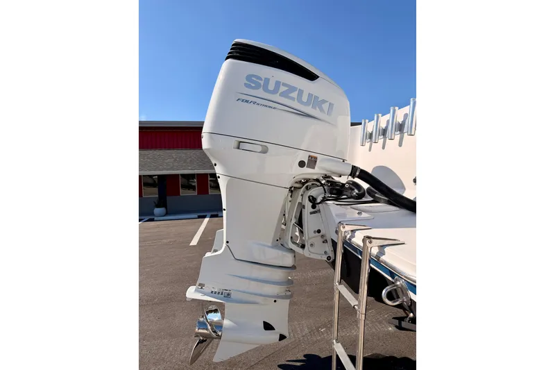 Slide: The Image of Suzuki outboard motor on 2007 Pro-Line 32 Express boat, parked outdoors. - 45
