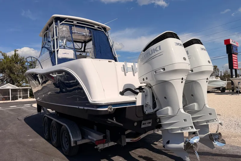 Slide: The Image of 2007 Pro-Line 32 Express boat with dual Suzuki 300 outboard engines on a trailer. - 6