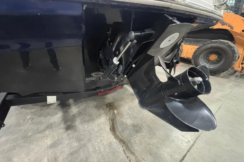 Slide: The Image of 2021 Chaparral 23 SSi boat propeller and stern drive in a garage setting. - 10