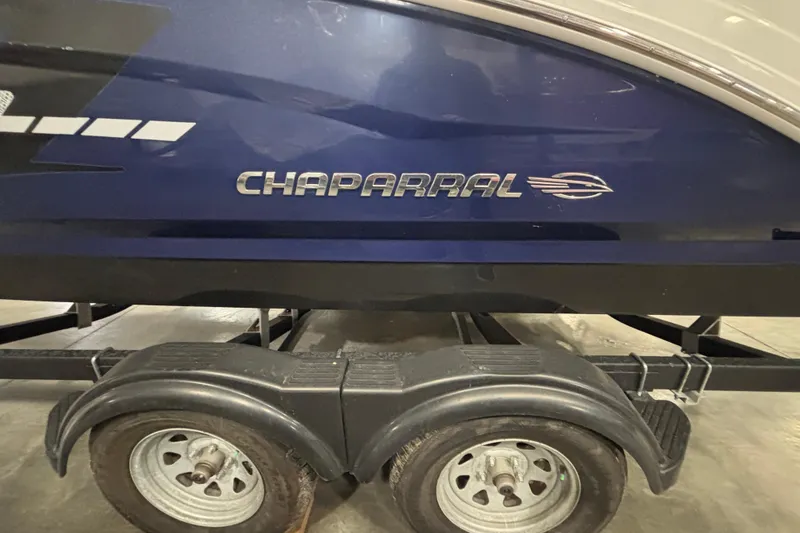 Slide: The Image of 2021 Chaparral 23 SSi boat on trailer, side view with logo visible. - 11