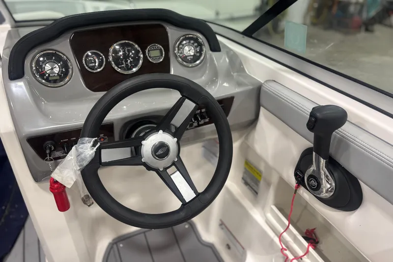 Slide: The Image of Steering wheel and controls of 2021 Chaparral 23 SSi boat cockpit. - 12