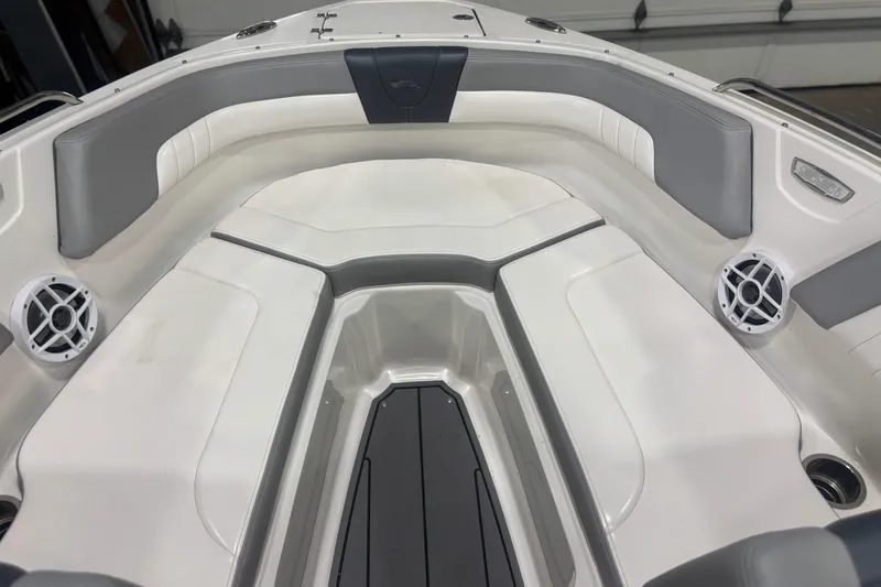 Slide: The Image of 2021 Chaparral 23 SSi boat interior with gray and white seating and speakers. - 15