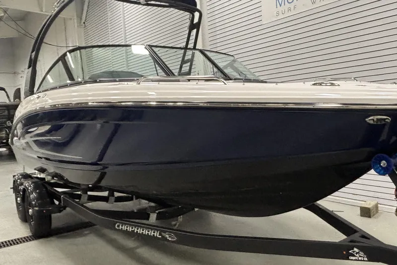 The Image of 2021 Chaparral 23 SSi boat on trailer in showroom setting. - 2