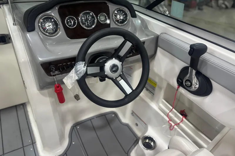 Slide: The Image of 2021 Chaparral 23 SSi boat dashboard with steering wheel and controls. - 20